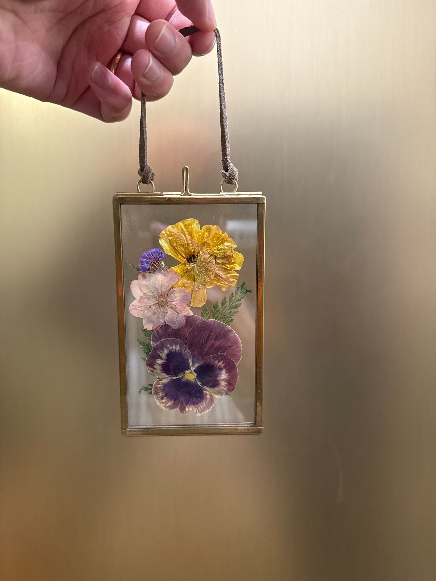 Pressed flowers in hanging glass