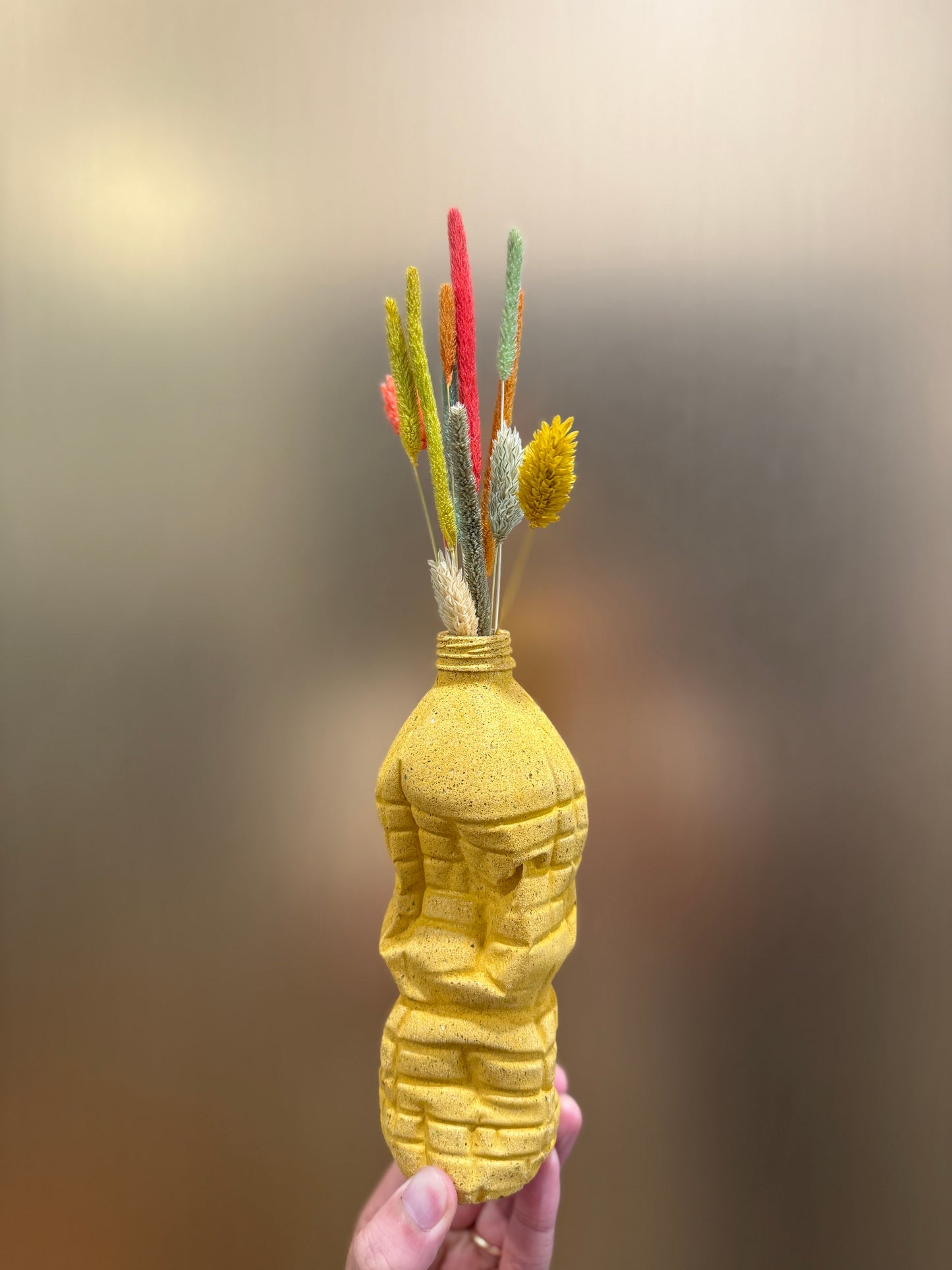 Crashed bottle with dry flowers