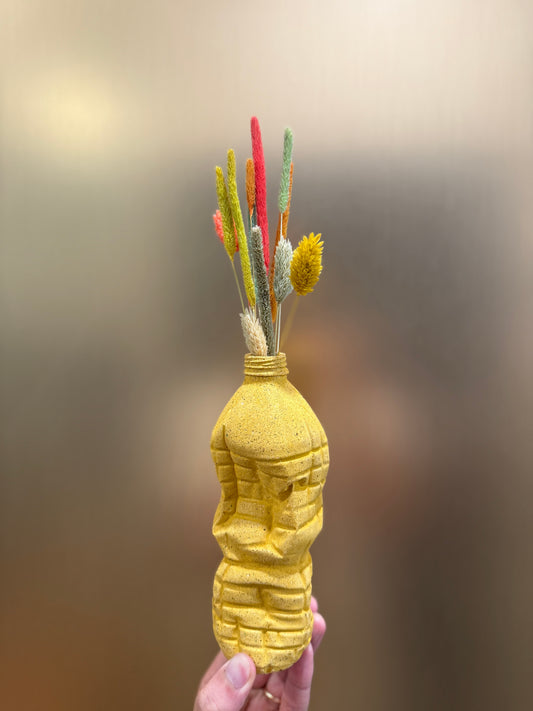 Crashed bottle with dry flowers