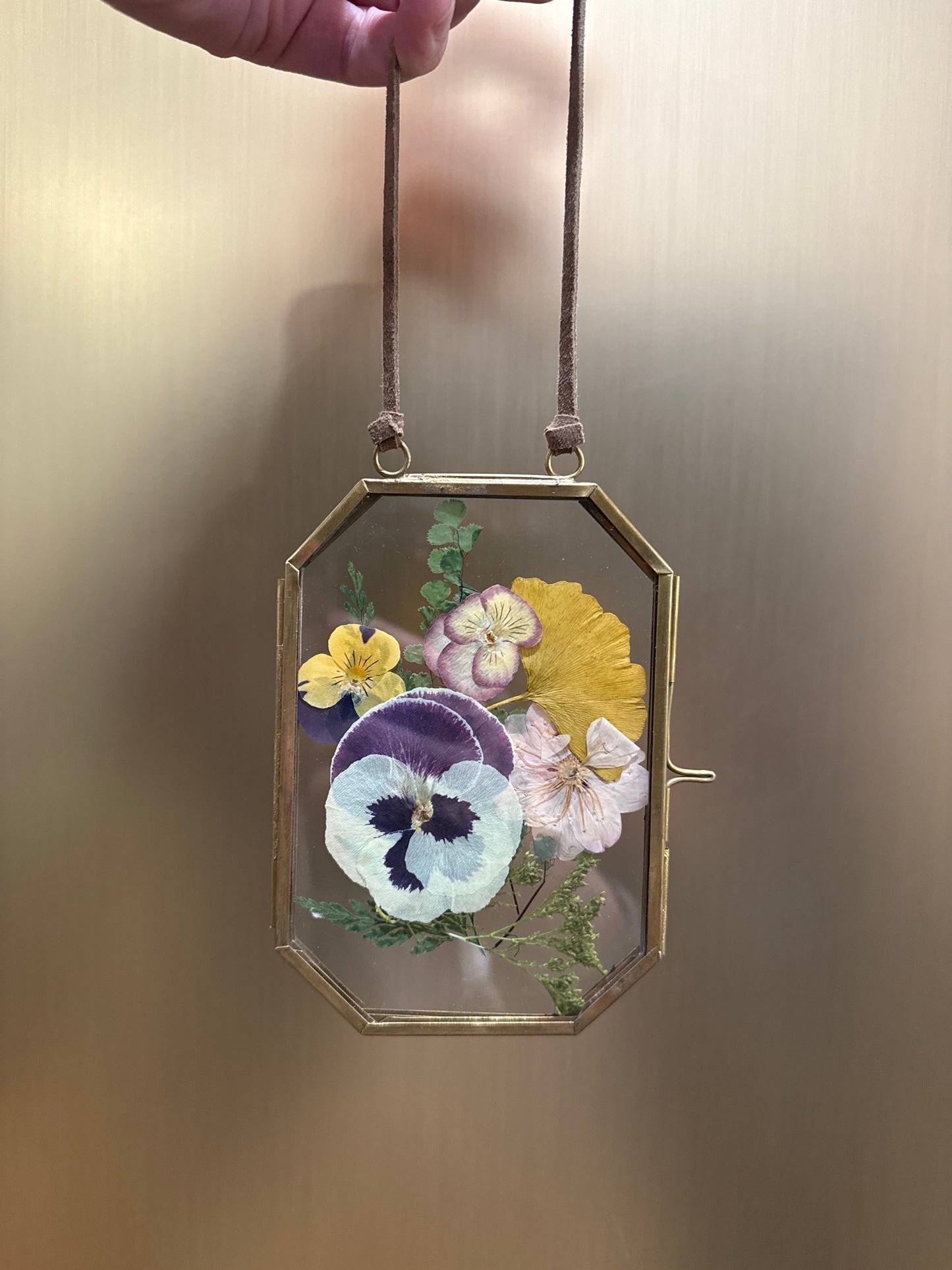 Pressed flowers in hanging glass