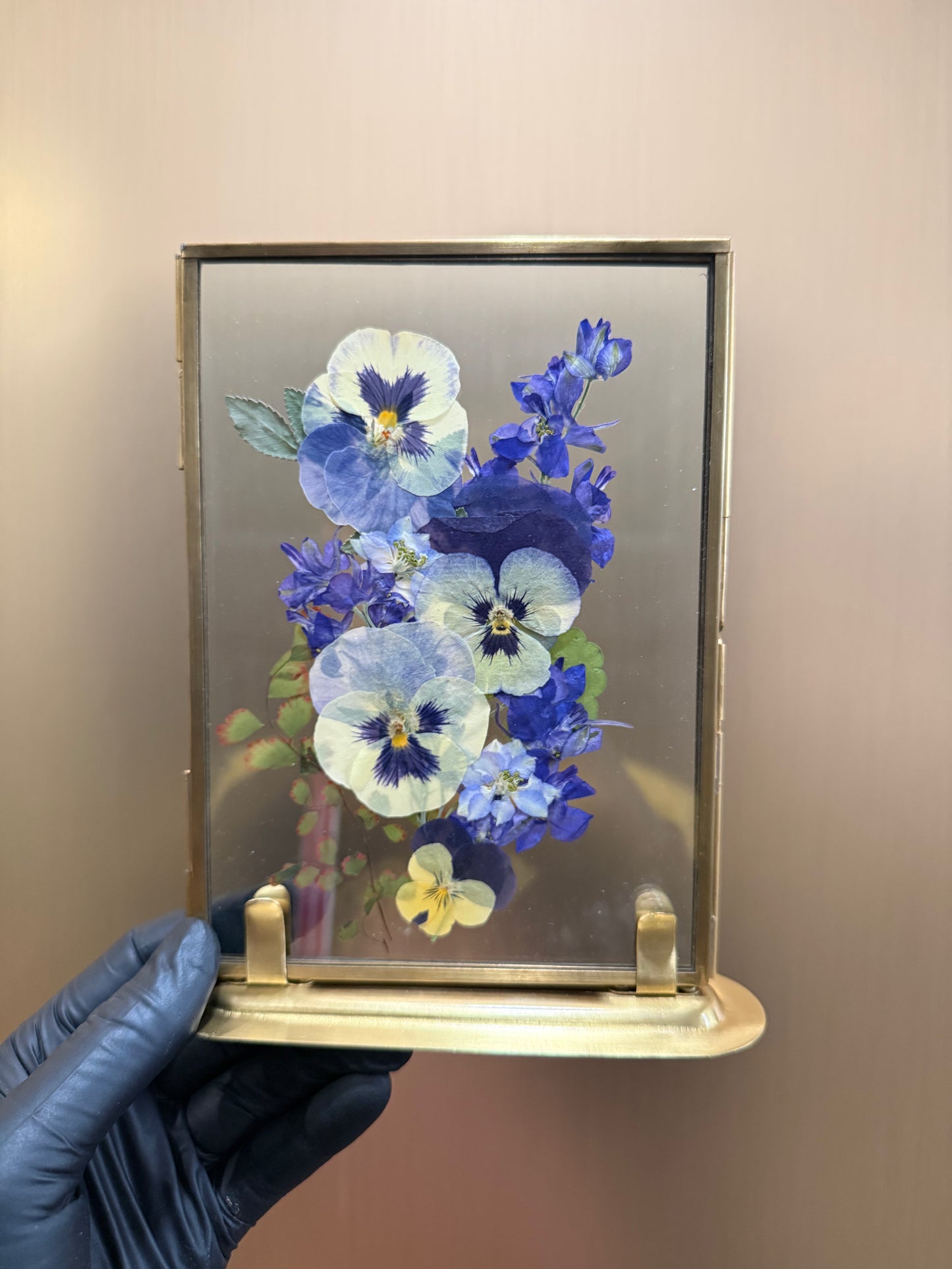 Blue petals in standing glass frame