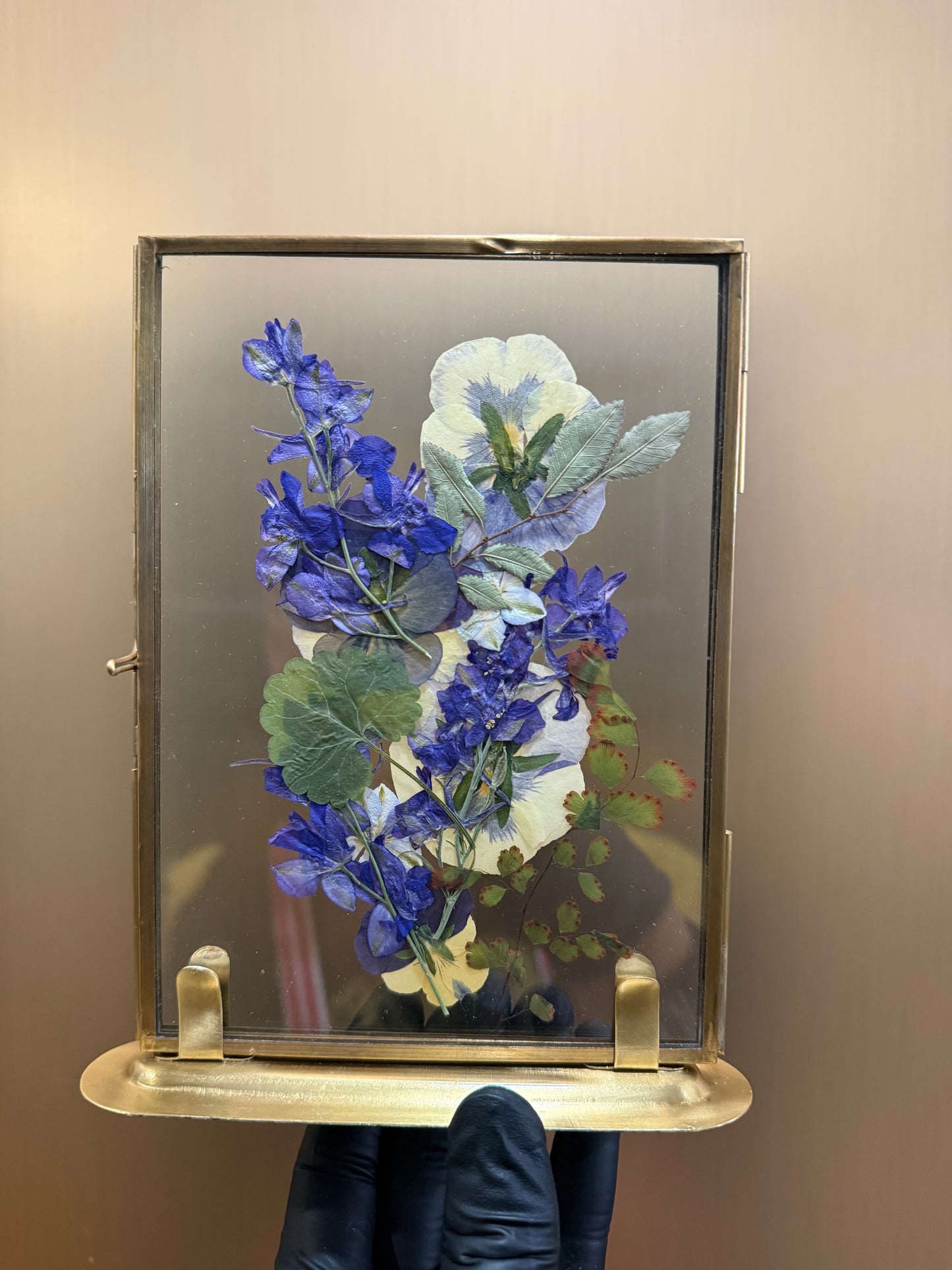 Blue petals in standing glass frame